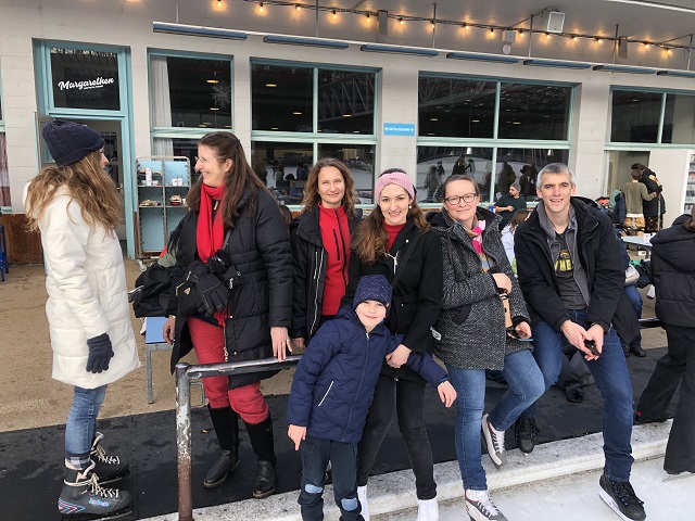 Group of Centrepoint members at an ice skating rink smiling at the camera