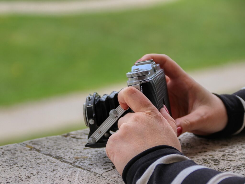 A close up of a pair of female hands holding a camera